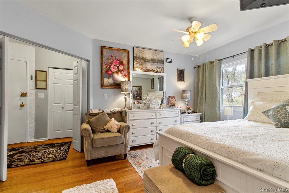 103 Wiltshire Road, Unit D11 Scarsdale, NY 10583 - Photo 14 of 23 a spacious bedroom with a bed a couch and dresser