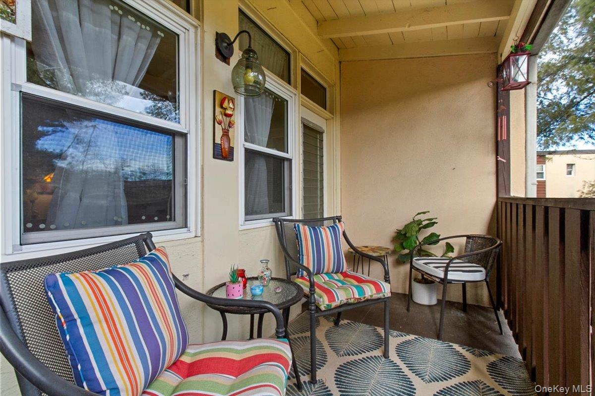 103 Wiltshire Road, Unit D11 Scarsdale, NY 10583 - Photo 20 of 23 a front view of a house with outdoor seating