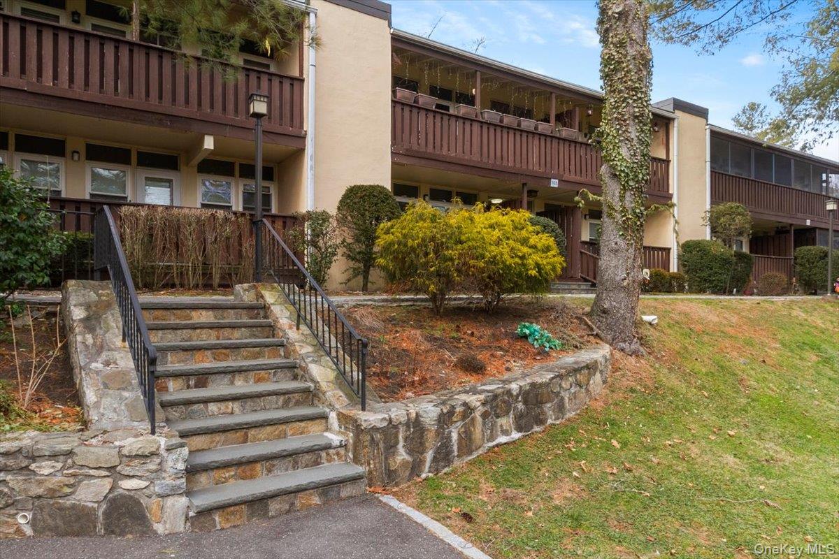 103 Wiltshire Road, Unit D11 Scarsdale, NY 10583 - Photo 22 of 23 a view of a house with a yard