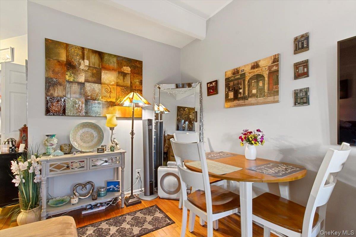 103 Wiltshire Road, Unit D11 Scarsdale, NY 10583 - Photo 5 of 23 a dining room with furniture and wooden floor