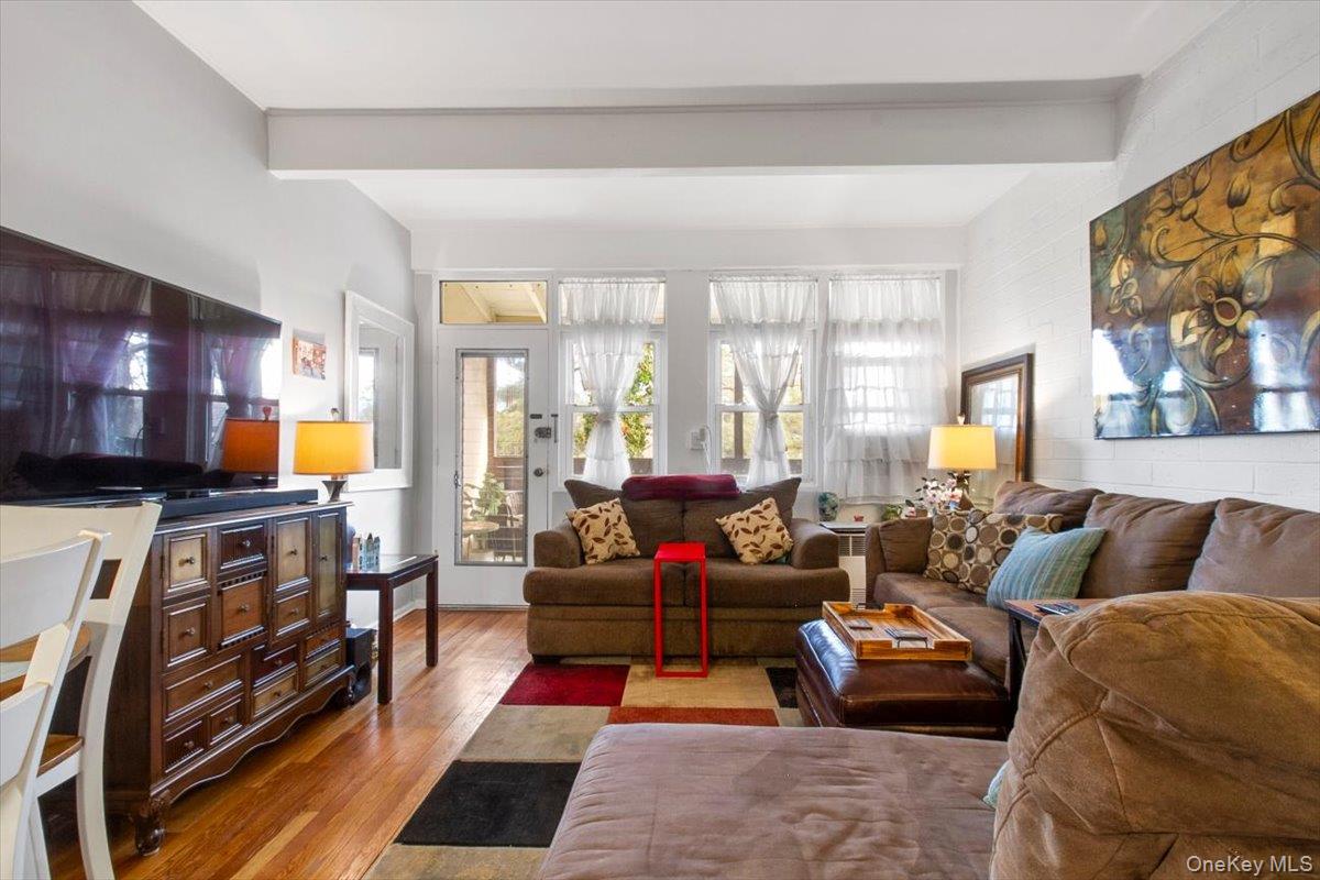 103 Wiltshire Road, Unit D11 Scarsdale, NY 10583 - Photo 7 of 23 a living room with furniture fireplace and a large window