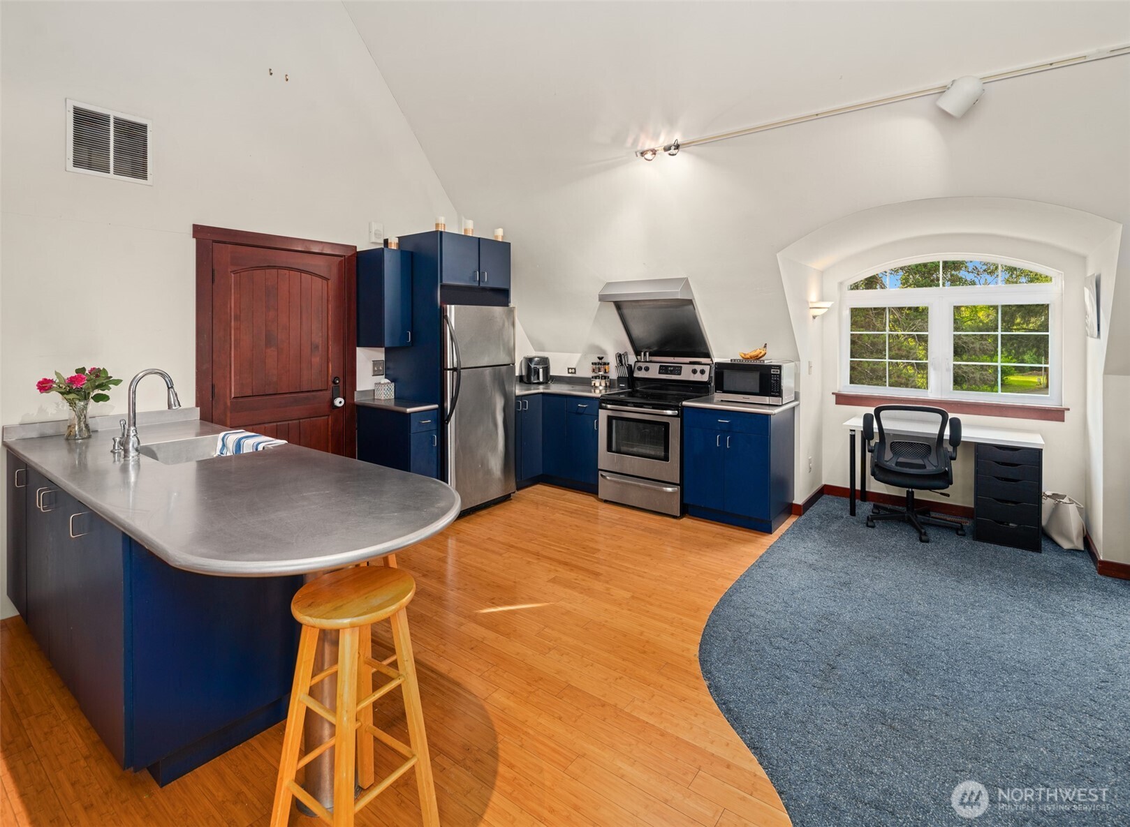 1000 Creso Road South Spanaway, WA 98387 - Photo 21 of 40 a kitchen with stainless steel appliances kitchen island granite countertop a sink stove and refrigerator