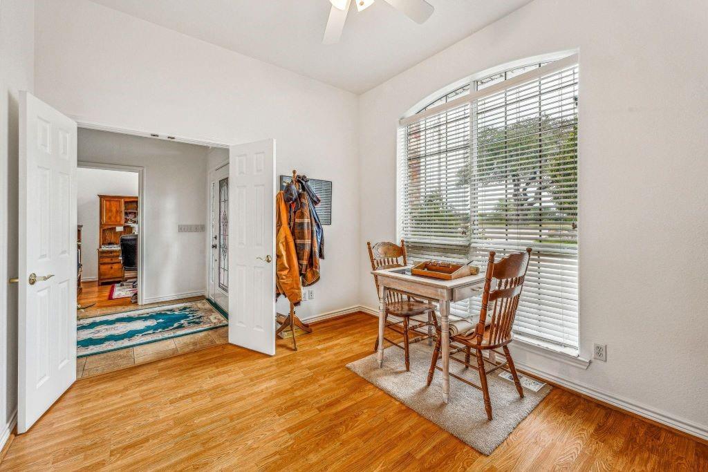 641 Comanche Lake Road Comanche, TX 76442 - Photo 14 of 34 a view of a room with furniture wooden floor and windows
