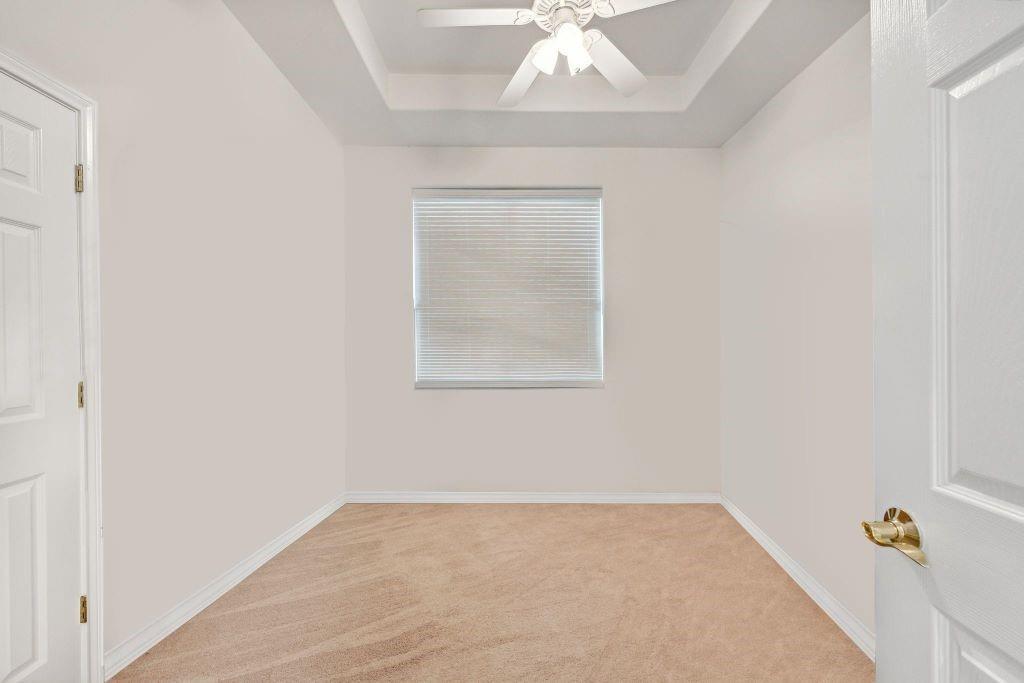 641 Comanche Lake Road Comanche, TX 76442 - Photo 22 of 34 an empty room with a chandelier fan