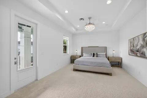 a spacious bedroom with a bed and lamp