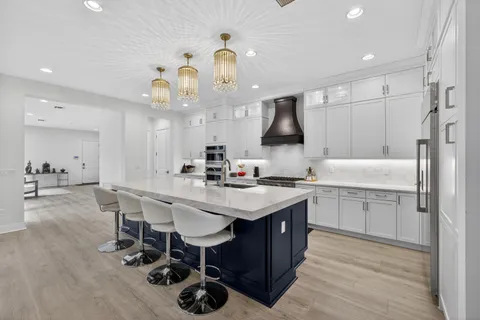 a kitchen with a sink cabinets and wooden floor