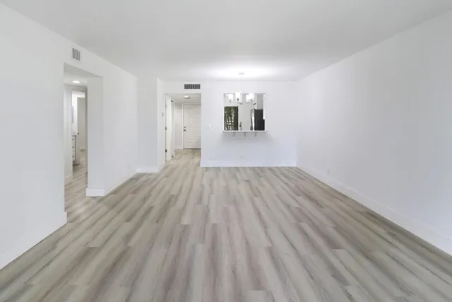 a view of a room with wooden floor