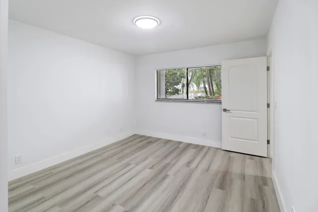 an empty room with wooden floor