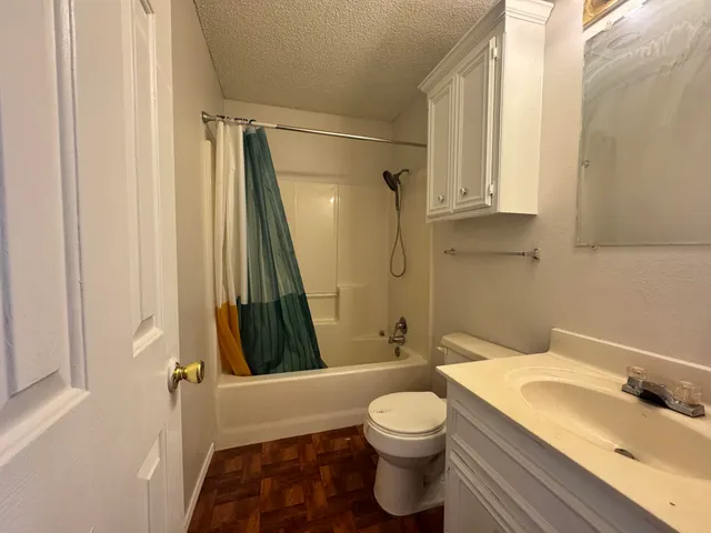 a bathroom with a sink a toilet and a bathtub
