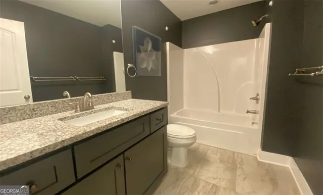 a living room with furniture flowerpot and wooden floor