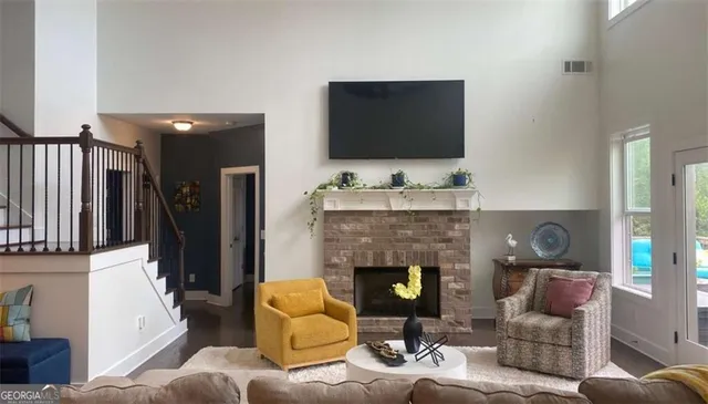 a living room with furniture and a floor to ceiling window