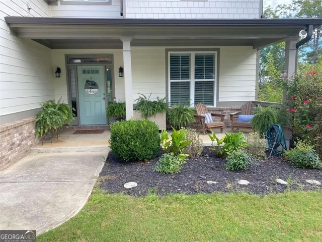 a bedroom with a bed a flat screen tv and view of bathroom