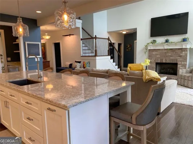 a living room with furniture a flat screen tv and a window