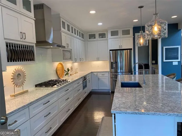 a bedroom with a bed a flat screen tv and a fireplace