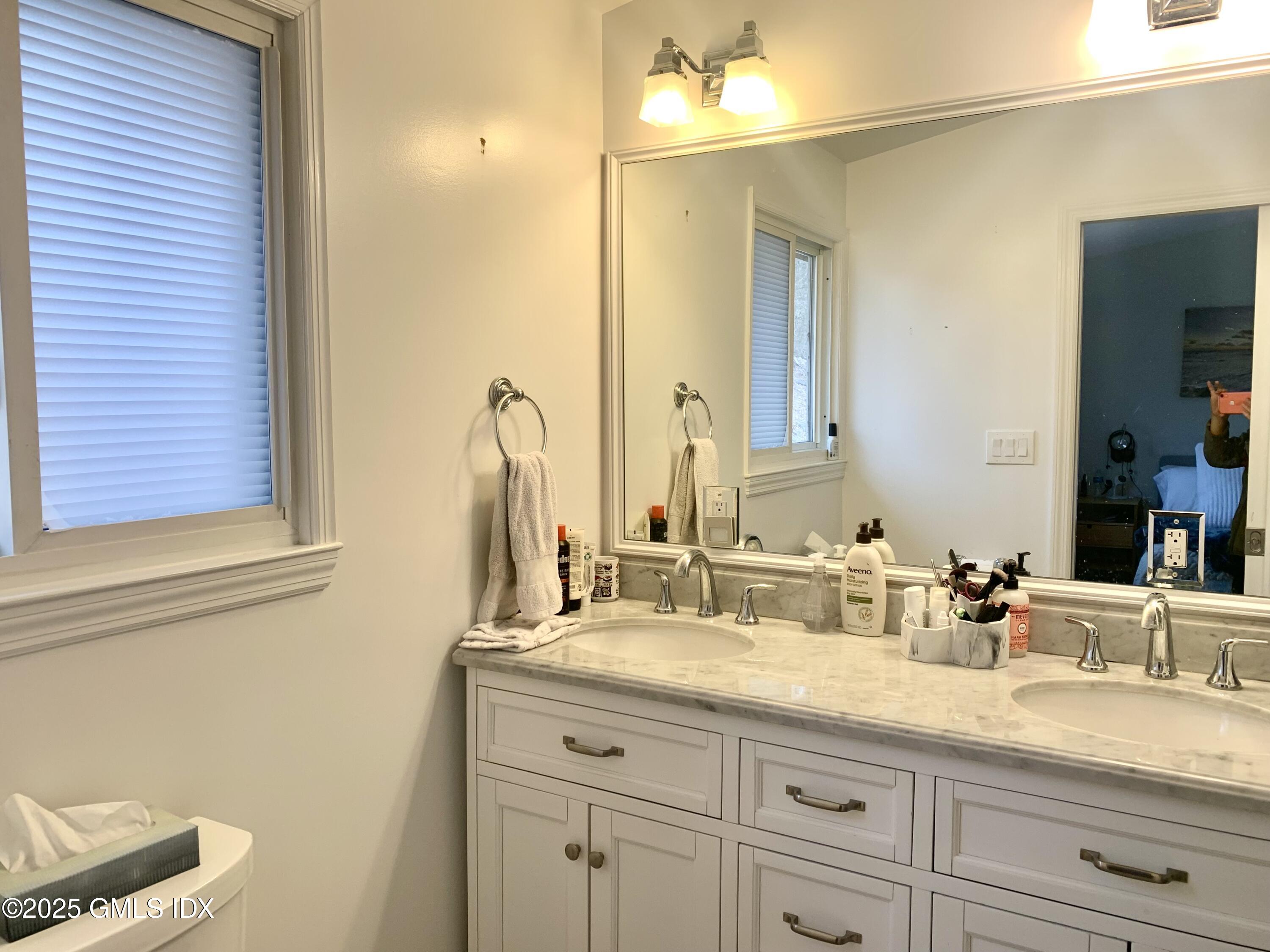 67 Florence Road Riverside, CT 06878 - Photo 12 of 23 a bathroom with a sink and a mirror