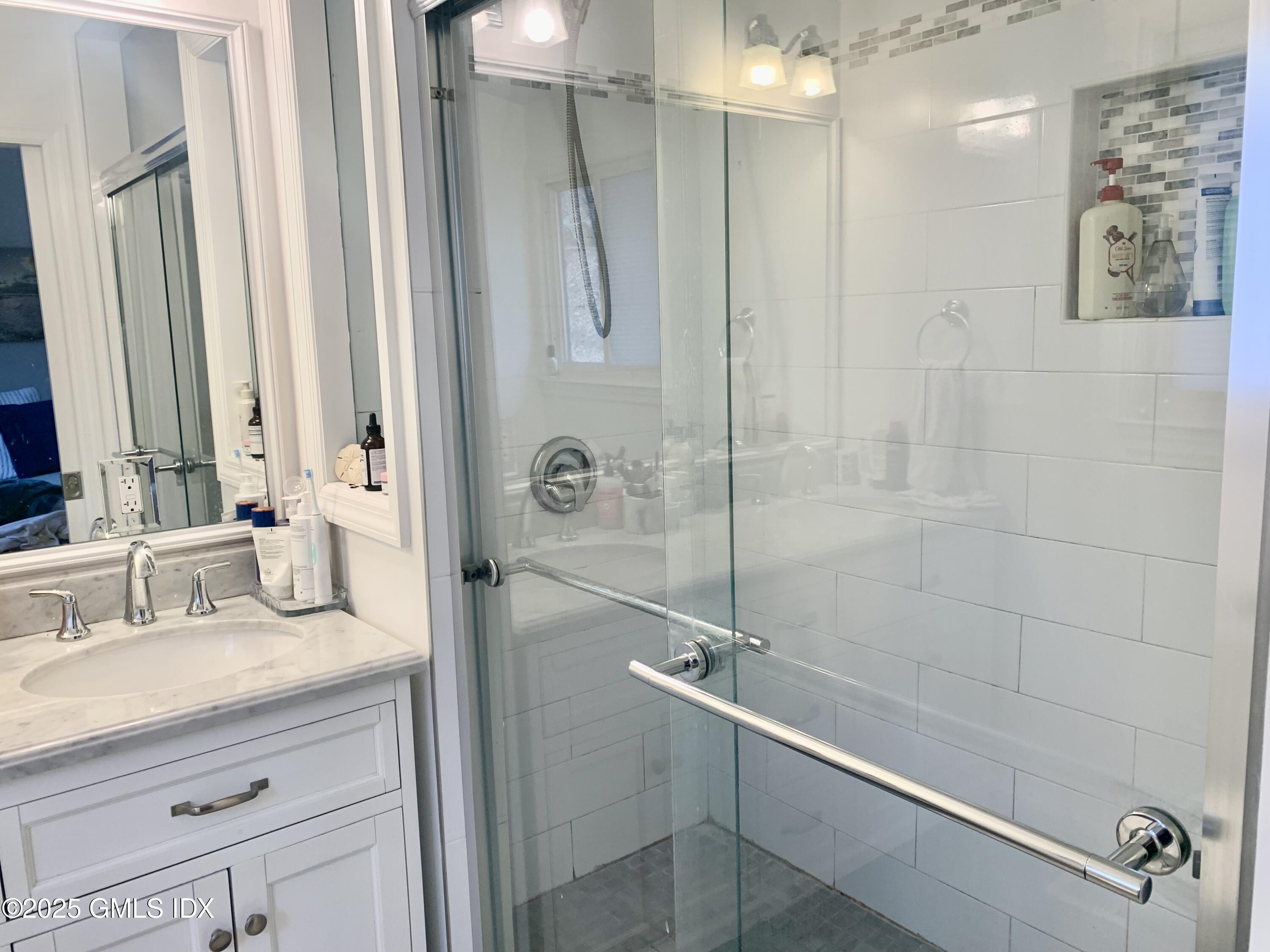 67 Florence Road Riverside, CT 06878 - Photo 13 of 23 a bathroom with a granite countertop shower sink vanity and mirror