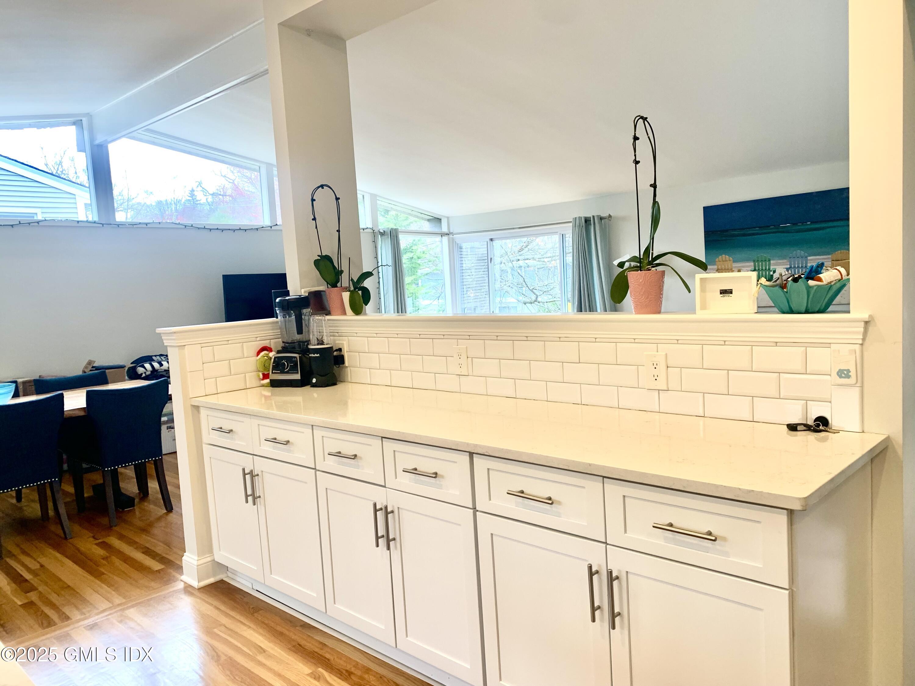 67 Florence Road Riverside, CT 06878 - Photo 4 of 23 a sink with white cabinets and wooden floor