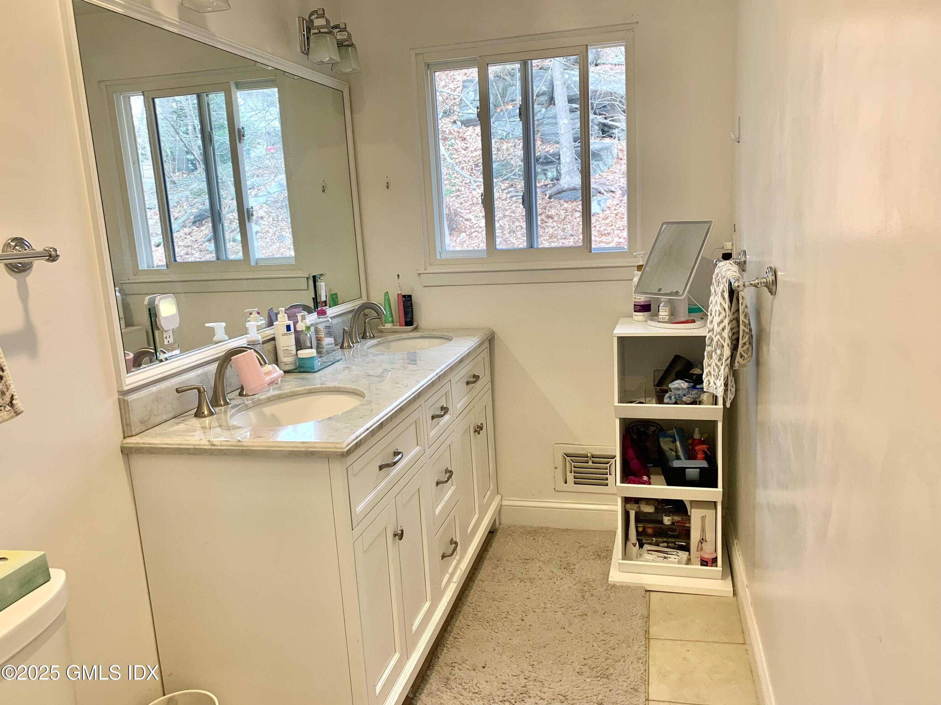 67 Florence Road Riverside, CT 06878 - Photo 10 of 23 a bathroom with a sink and a mirror