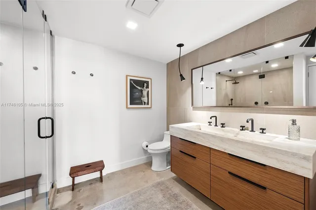 a bedroom with furniture and a painting on the wall