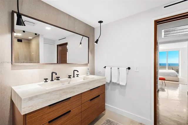 a living room with furniture a window and kitchen view