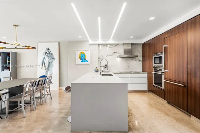 a roof deck with table and chairs under an umbrella