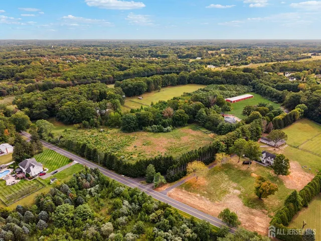 an aerial view of a house with a yard and lake view