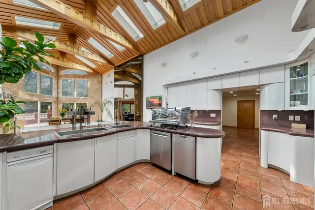 a bedroom with a bed and a dresser next to a window