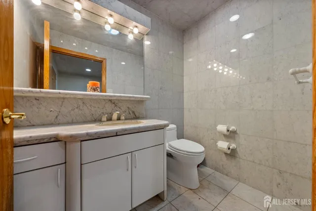 a large bedroom with wooden floor closet and windows