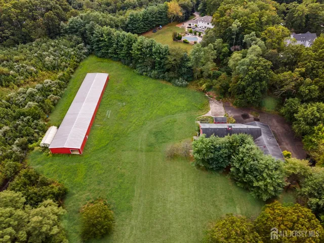 an aerial view of residential building and lake