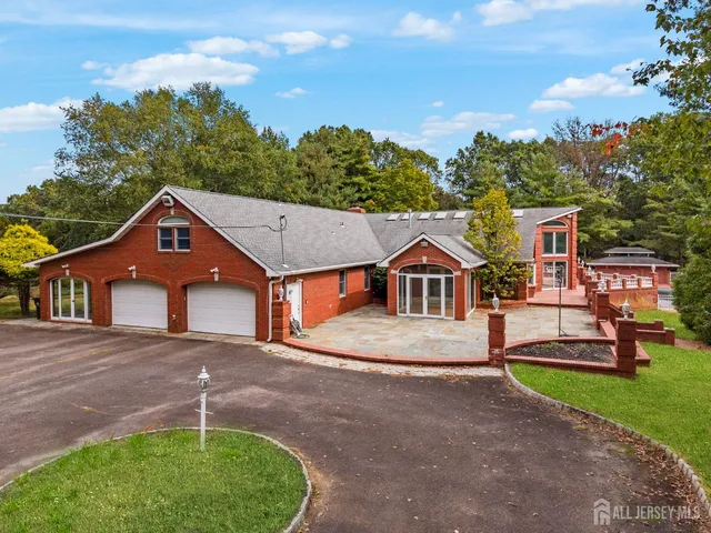 a view of a patio with a table and chairs and potted plants