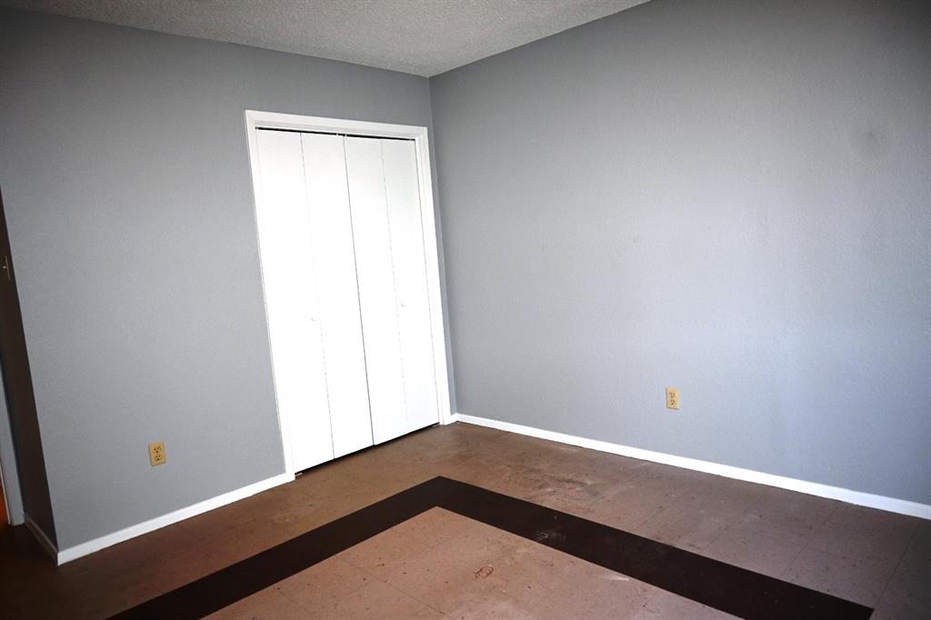 817 Lexington Road Elgin, TX 78621 - Photo 12 of 20 an empty room with wooden floor