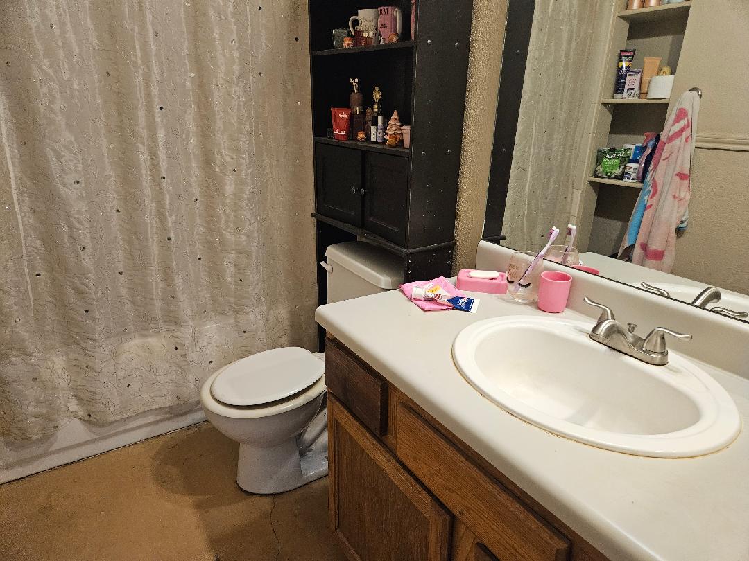 817 Lexington Road Elgin, TX 78621 - Photo 17 of 20 a bathroom with a sink toilet and shower
