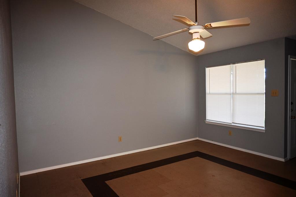 817 Lexington Road Elgin, TX 78621 - Photo 2 of 20 wooden floor in an empty room with a window
