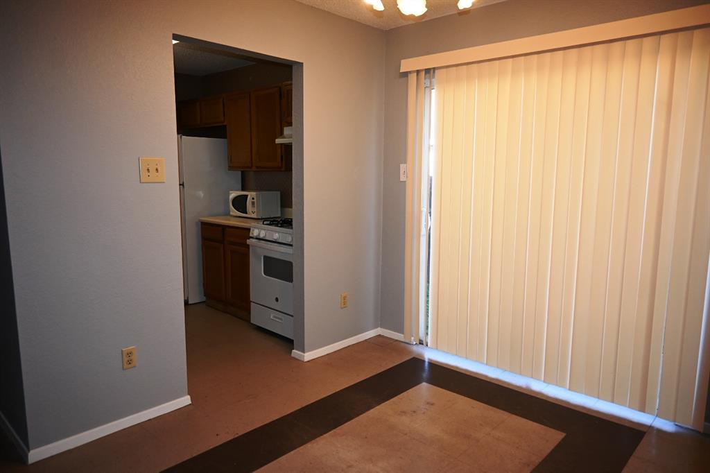817 Lexington Road Elgin, TX 78621 - Photo 6 of 20 a view of a kitchen with an empty space and a window