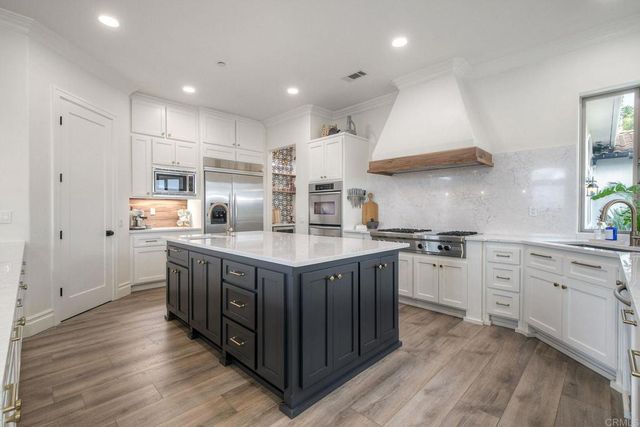 a dining room with kitchen island a table and chairs