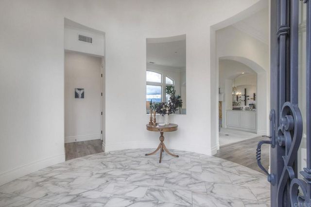 a living room with fireplace furniture and a large window