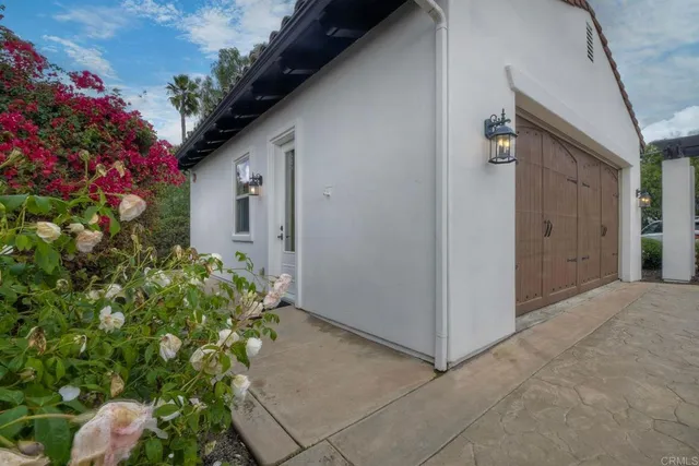 an aerial view of residential house with green space and fog