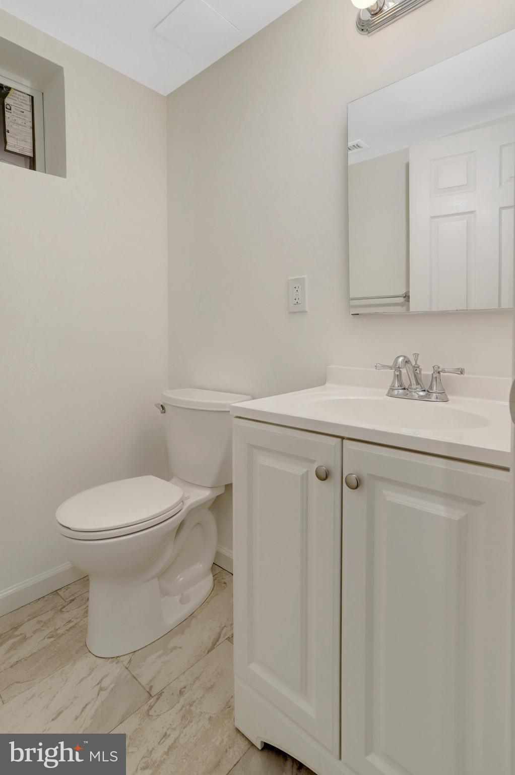 8626 Kerry Lane Springfield, VA 22152 - Photo 14 of 48 a white toilet sitting next to a bathroom sink