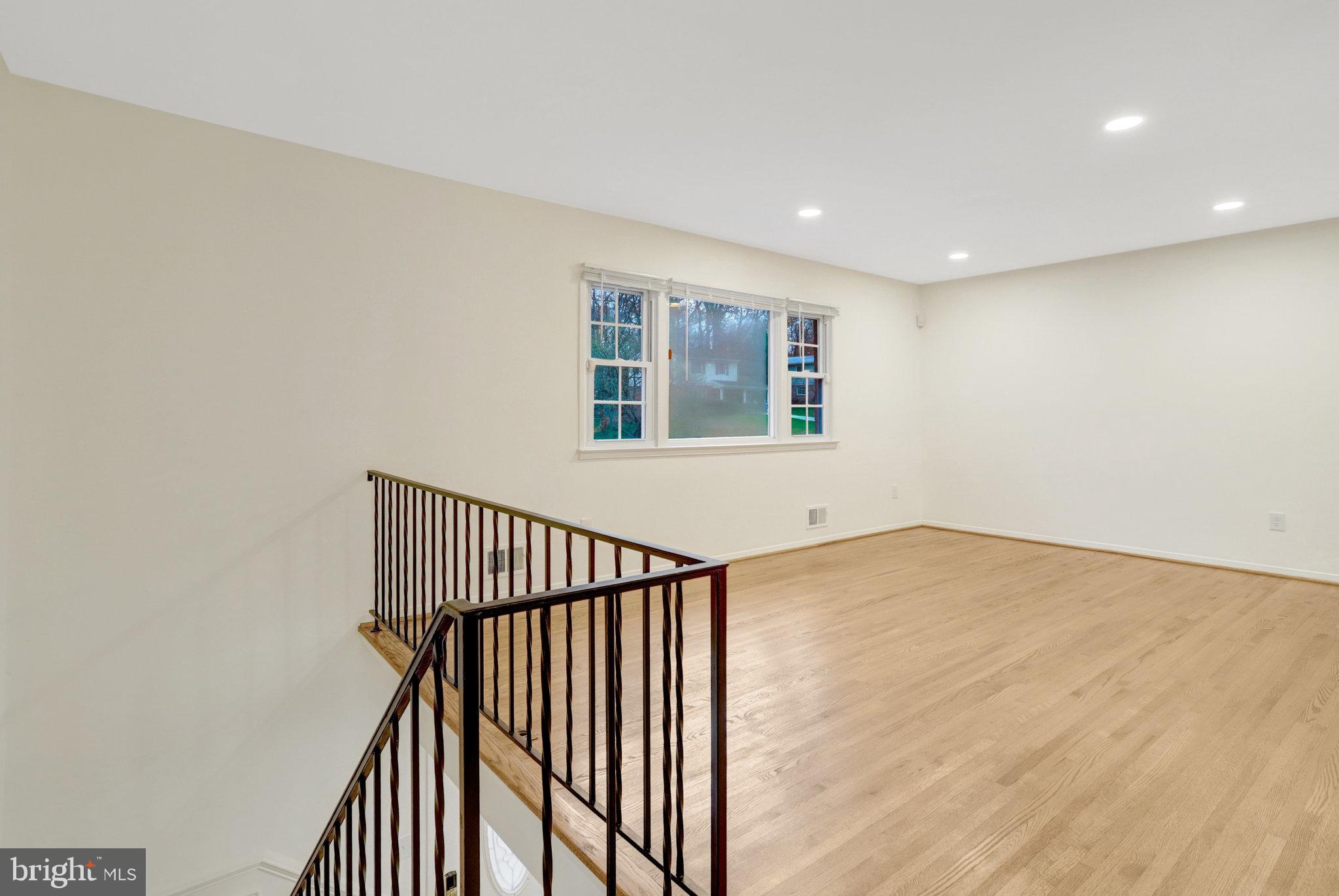 8626 Kerry Lane Springfield, VA 22152 - Photo 16 of 48 a view of an empty room with wooden floor and a window