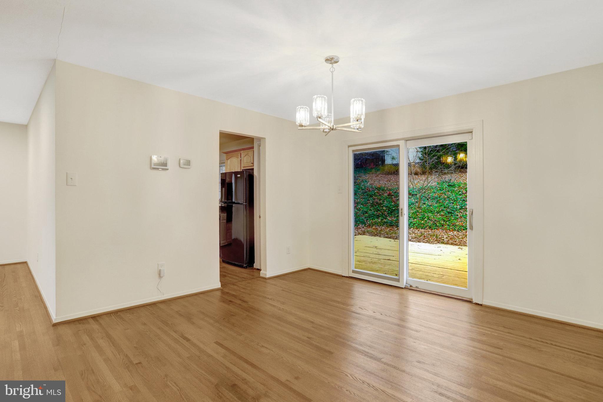 8626 Kerry Lane Springfield, VA 22152 - Photo 21 of 48 an empty room with wooden floor and windows