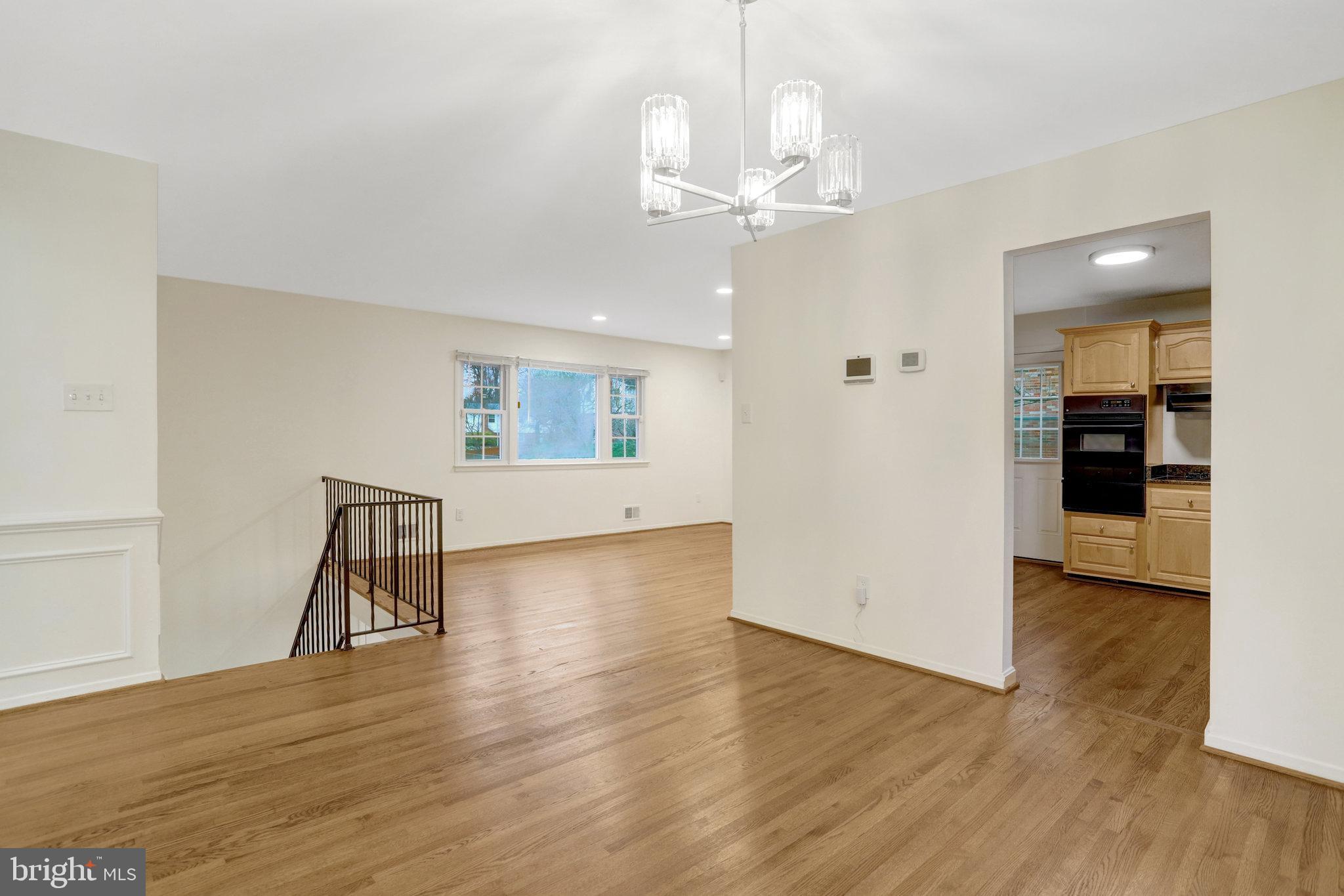 8626 Kerry Lane Springfield, VA 22152 - Photo 22 of 48 an empty room with wooden floor and entrance
