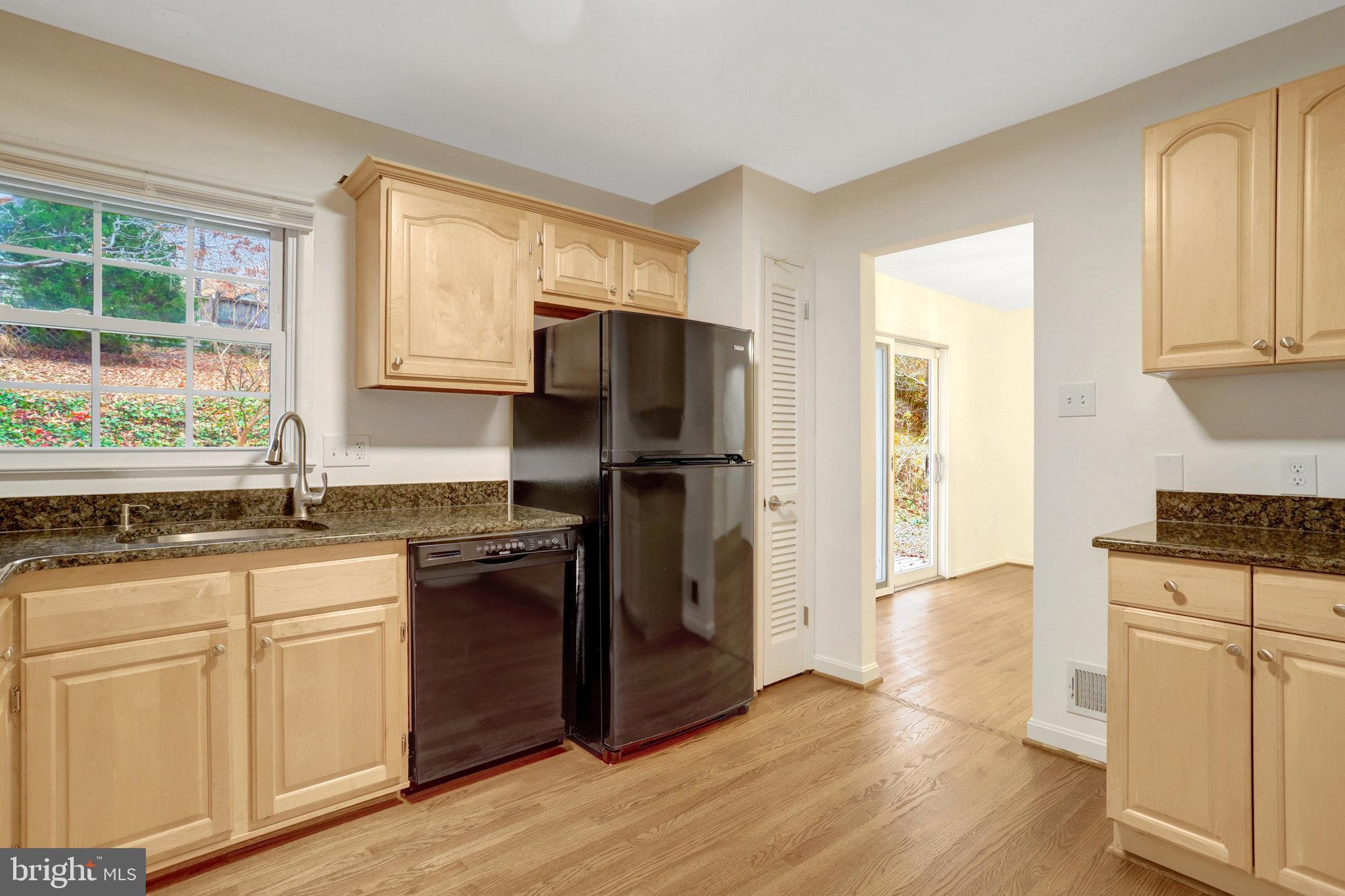 8626 Kerry Lane Springfield, VA 22152 - Photo 26 of 48 a kitchen with granite countertop a refrigerator stove top oven and sink