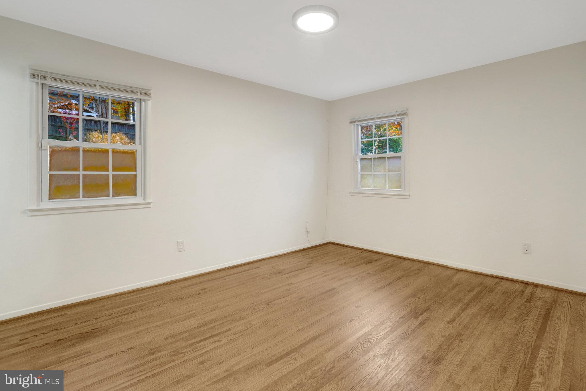 8626 Kerry Lane Springfield, VA 22152 - Photo 30 of 48 an empty room with wooden floor and windows