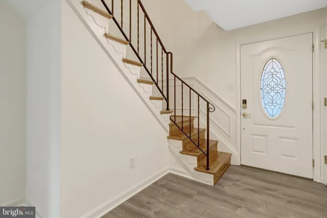 a view of entryway with wooden floor and stairs