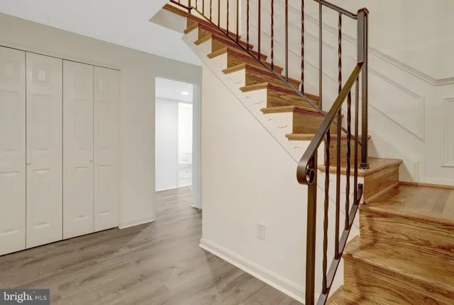 a view of entryway with wooden floor and stairs