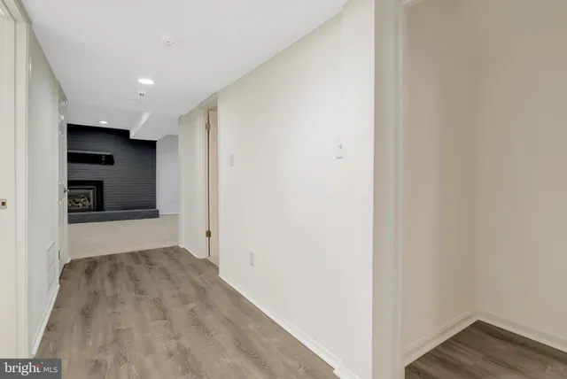 a view of hallway with wooden floor