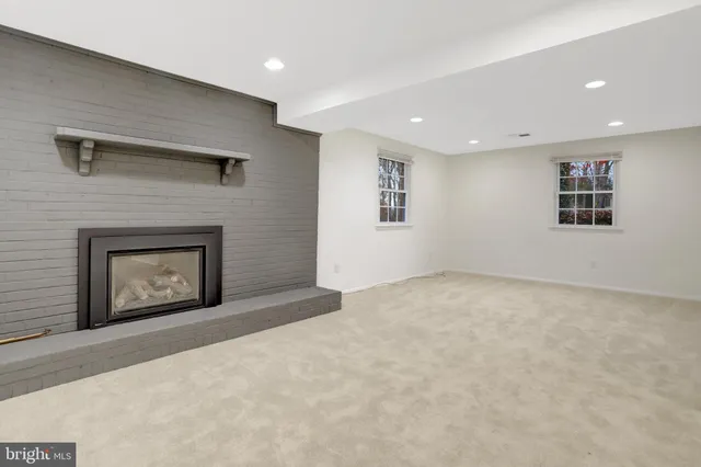 a view of an empty room with a fireplace