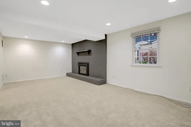 a view of empty room with a fireplace