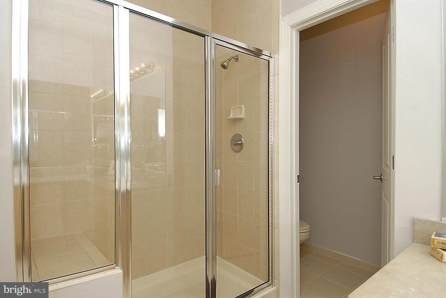 1360 Monroe Street Northwest, Unit B Washington, DC 20010 - Photo 14 of 19 a bathroom with a glass shower door