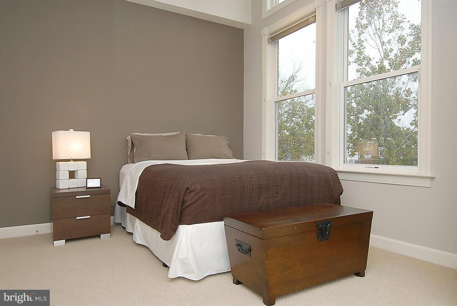 1360 Monroe Street Northwest, Unit B Washington, DC 20010 - Photo 15 of 19 a bed sitting in a bedroom next to a window